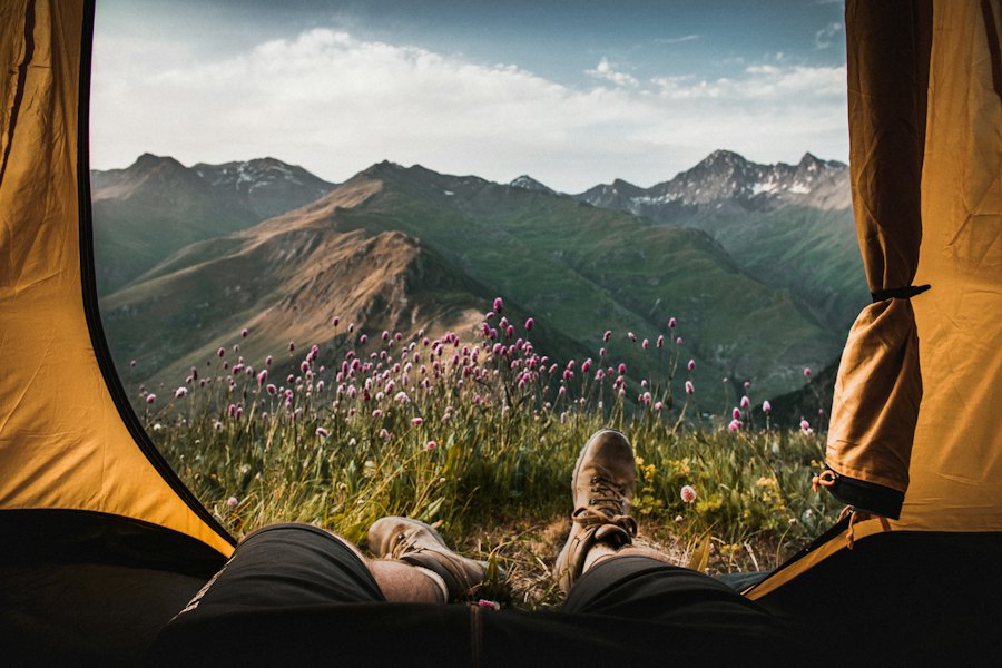View of green mountains from inside an open tent